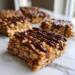 Close-up of a delicious, chewy homemade protein bars drizzled with melted dark chocolate.