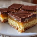 Four squares of Amazing 3-Layer twix Bars showing the shortbread base, caramel layer, and chocolate topping.