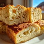 Close-up of thick, airy slices showing the open crumb structure of sourdough pancakes.