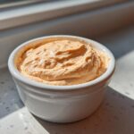 A creamy, orange-hued Copycat Classic Burger Spread Sauce mounded in a small white ramekin.