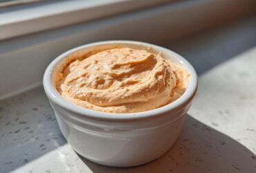 A creamy, orange-hued Copycat Classic Burger Spread Sauce mounded in a small white ramekin.