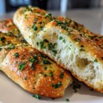 Close-up of Copycat Italian Restaurant Soft Garlic Breadsticks, showing the fluffy, airy interior texture.