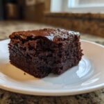 A single square of rich, dark, fudgy Greek Yogurt Brownies Under 100 Calories on a white plate.