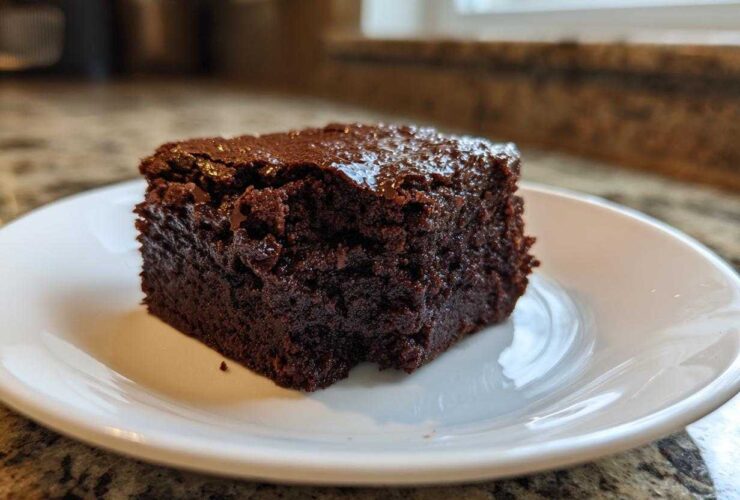 A single square of rich, dark, fudgy Greek Yogurt Brownies Under 100 Calories on a white plate.