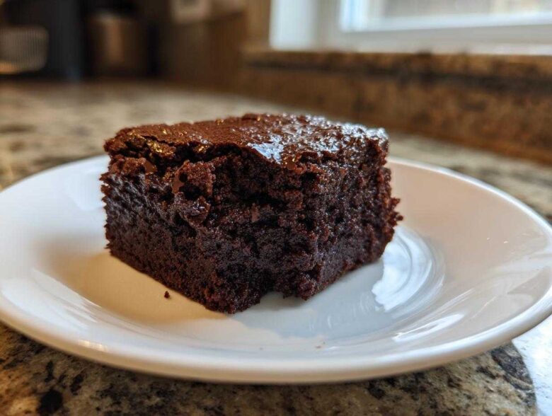 A single square of rich, dark, fudgy Greek Yogurt Brownies Under 100 Calories on a white plate.