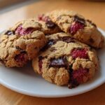 A stack of freshly baked Gluten-Free Strawberry Chocolate Chip Cookies featuring melted chocolate chunks and bright red strawberry pieces.