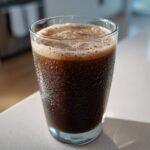 A cold, dark brown Keto Creamy Chocolate Peanut Butter Shake in a glass showing condensation droplets.