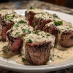 Four thick slices of perfectly cooked Keto Creamy Garlic Herb Pork Tenderloin covered in a rich, herbed cream sauce.