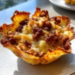 Close-up of a single Keto Crispy Cheese Taco Shell Bowl filled with melted cheese and seasoned ground meat.