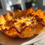 Close-up of a single Keto Crispy Cheese Taco Shell Bowl filled with seasoned ground meat and melted cheese.