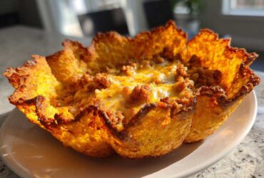 Close-up of a single Keto Crispy Cheese Taco Shell Bowl filled with seasoned ground meat and melted cheese.