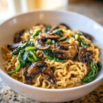 Close-up of One-Pot Creamy Mushroom Spinach Ramen with rich sauce and sautéed mushrooms.